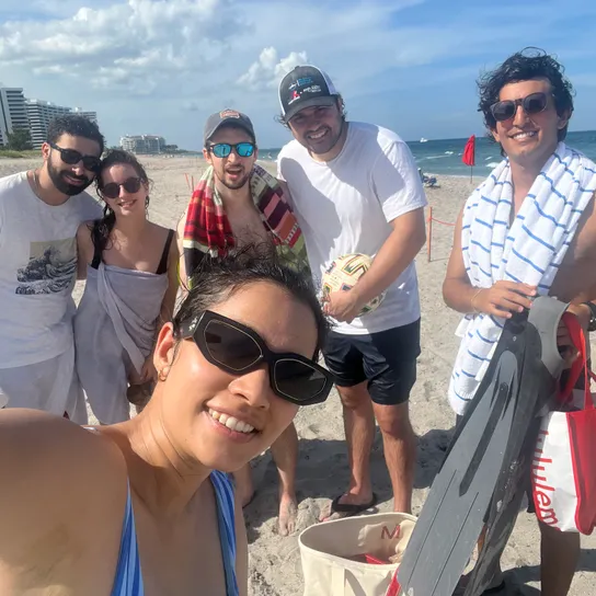 Shruti taking a selfie at the beach including (left to right) Baruch, Tal, Caleb, Jordan, and Ryan.
