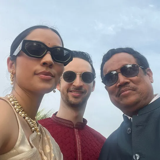 Selfie of Caleb, Shruti, and Shruti’s dad wearing sunglasses at an Indian wedding.