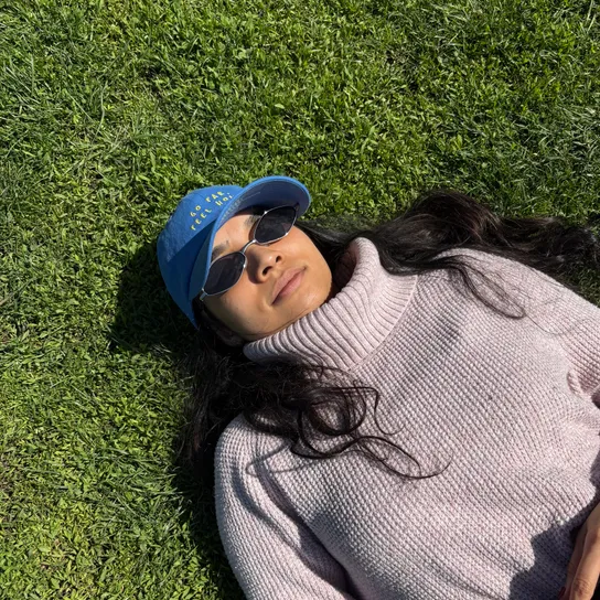 Shruti laying down in the grass at Prospect Park.